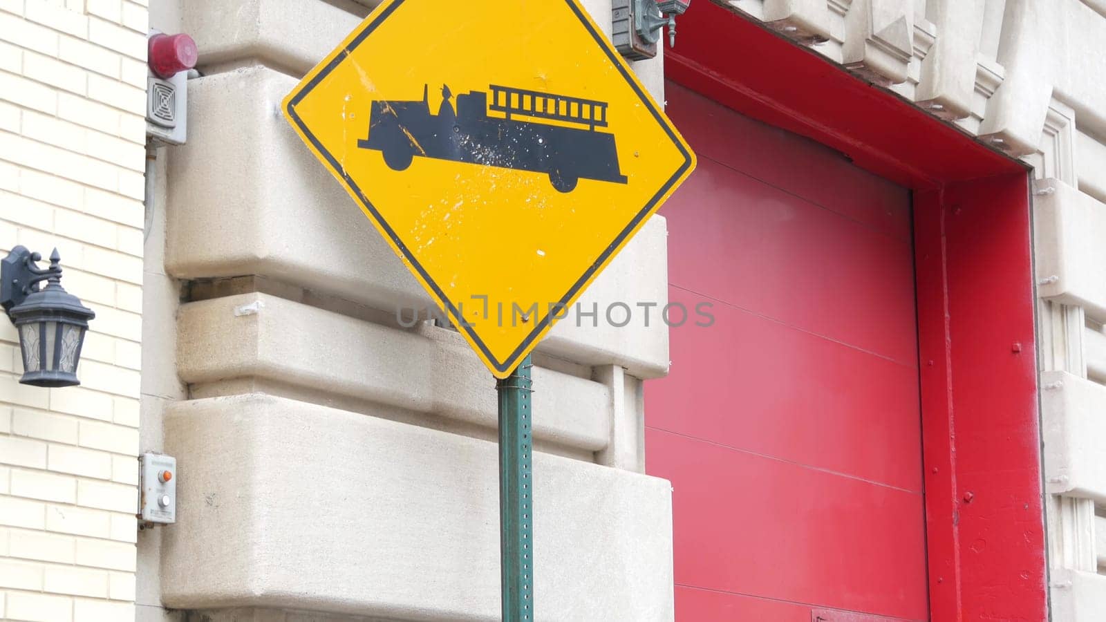 New York City, United States - 30 Aug 2023: NYFD sign, USA fire department truck, american firefighters vehicle or NYC fire fighter engine. Firemen station red gates, FD house or hall. Queens street.