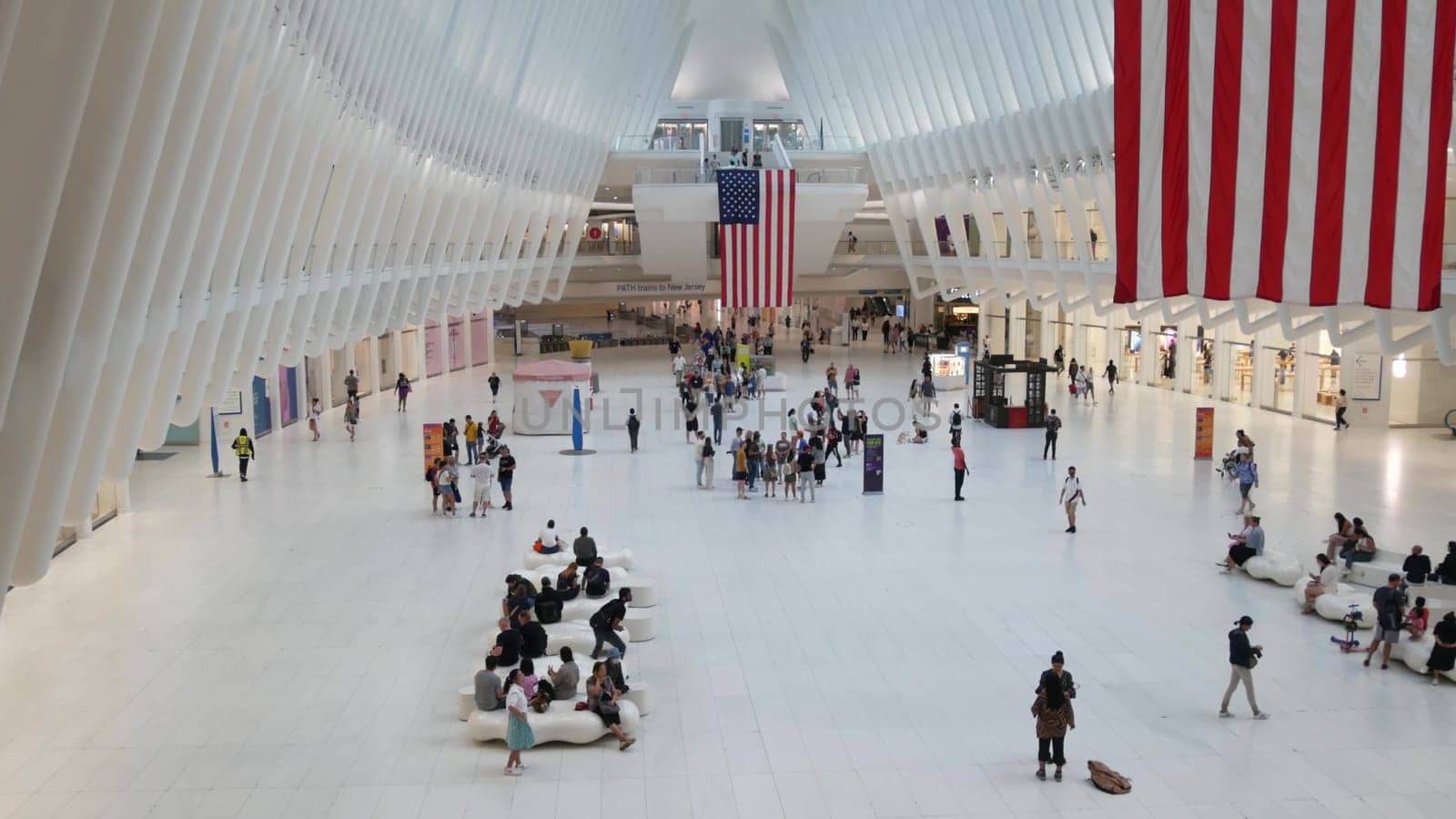 New York City, United States - 10 Sept 2023: World Trade Center Oculus transport hub architecture. Manhattan Downtown Financial District, USA urban life. People. September 11 remembrance american flag