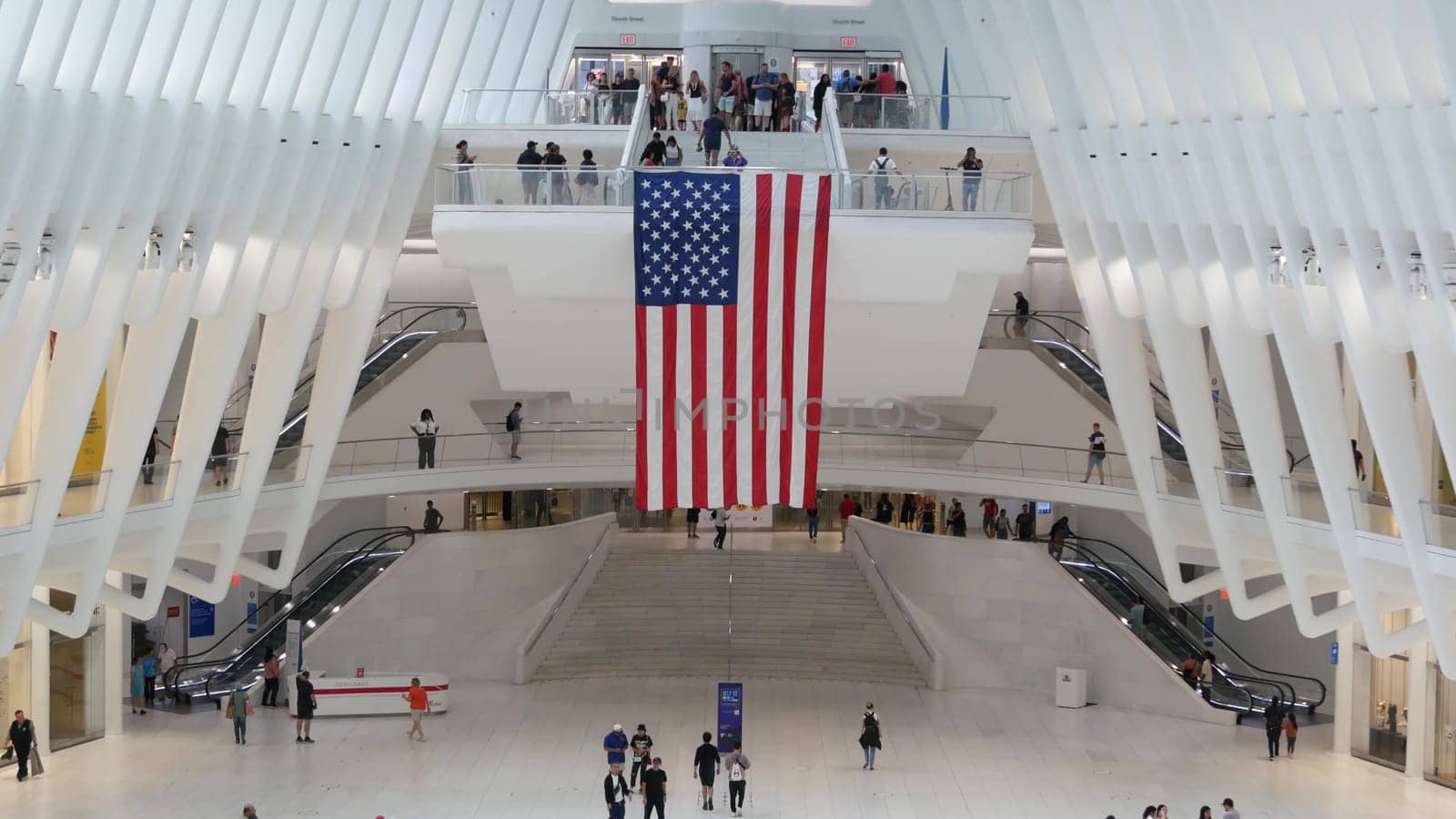 New York City, United States - 10 Sept 2023: World Trade Center Oculus transport hub architecture. Manhattan Downtown Financial District, USA urban life. People. September 11 remembrance american flag