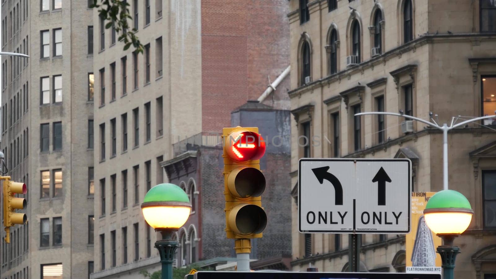New York City, United States - 8 Sep 2023: Subway entrance globe, orb lamp. Yellow traffic light, Manhattan Midtown road intersection, street crossroad sign. Metropolitan underground metro transport.