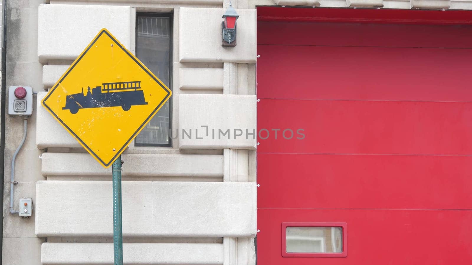 New York City, United States - 30 Aug 2023: NYFD sign, USA fire department truck, american firefighters vehicle or NYC fire fighter engine. Firemen station red gates, FD house or hall. Queens street.