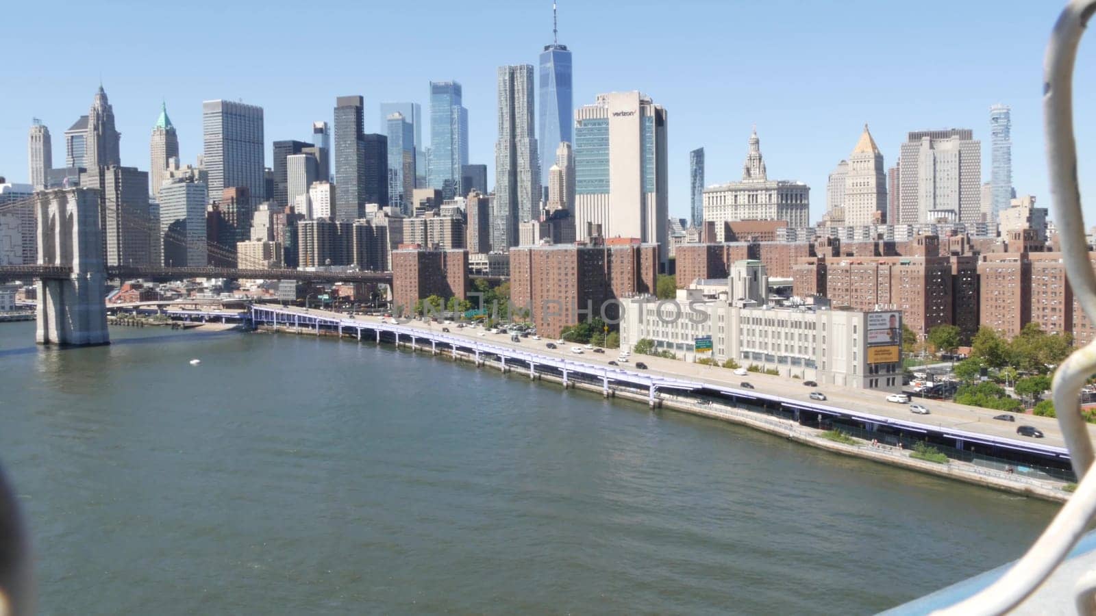 New York City, United States - 14 Sept 2023: Brooklyn Bridge from Manhattan Bridge. Downtown skyline, financial district cityscape, World Trade Center. Transport traffic, FDR Drive highway, East River