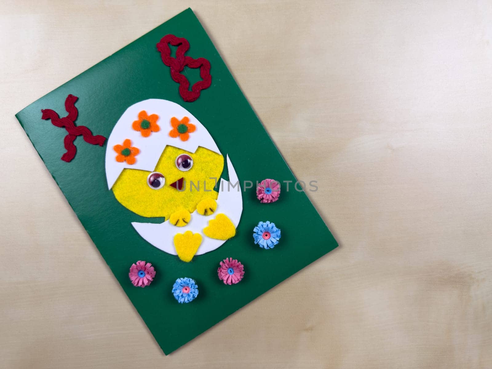 This delightful handmade Easter card features a cute chick emerging from an egg, adorned with colorful flowers. Perfect for sending warm wishes and spreading joy during the holiday season