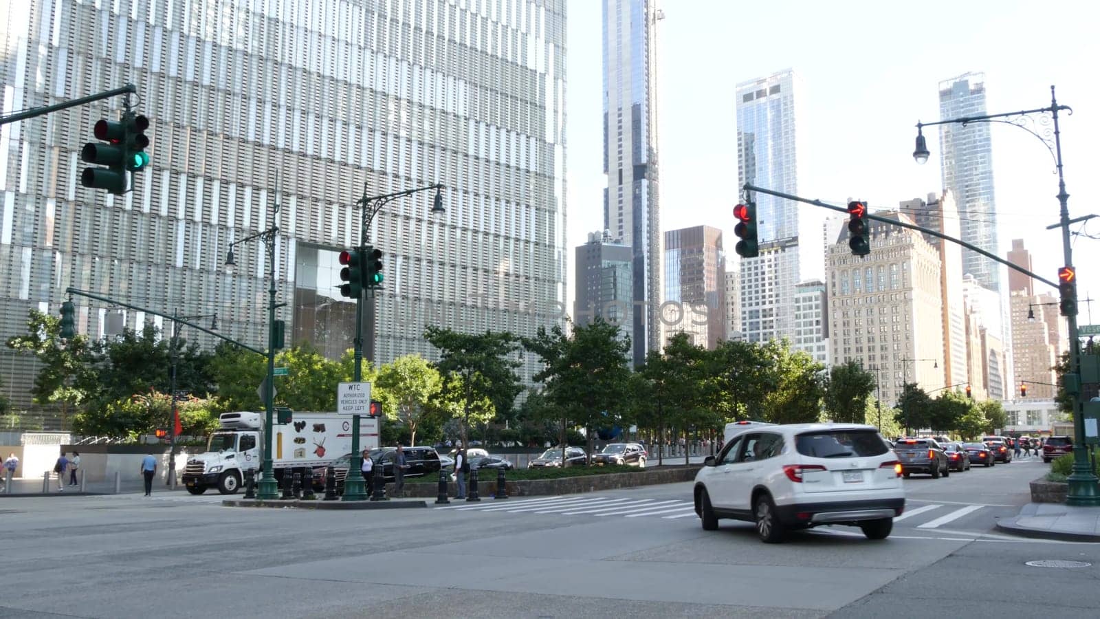 New York City, United States - 31 Aug 2023: Manhattan Downtown Financial District street crossroad intersection. Urban road car traffic. People pedestrian. World Trade Center memorial area.