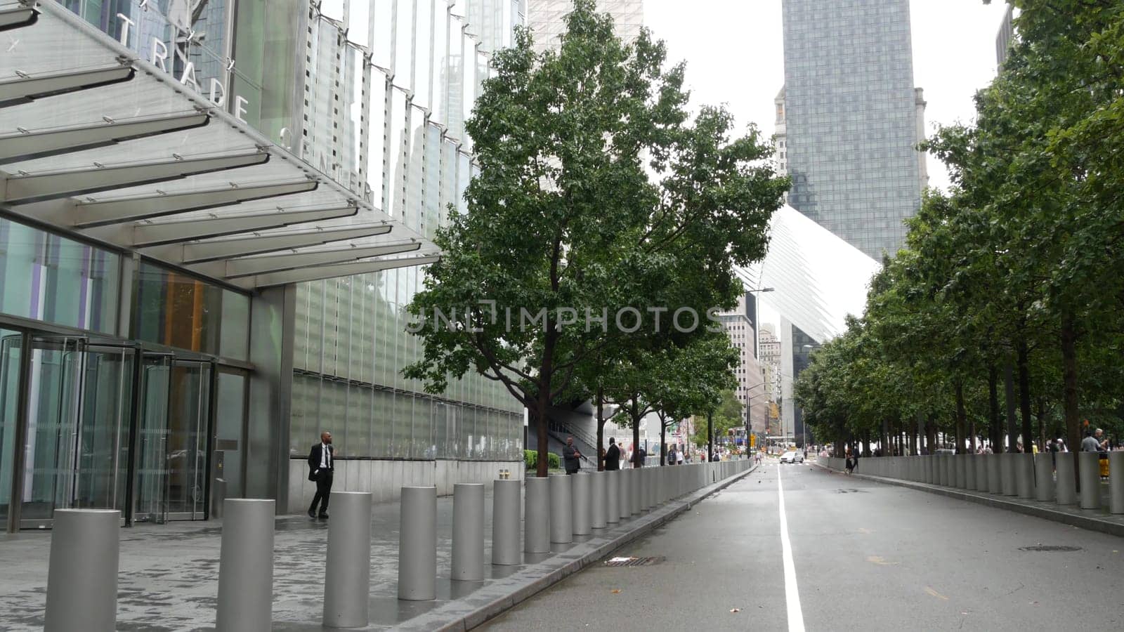 New York City, United States - 10 Sept 2023: Manhattan Downtown Financial District. People near World Trade Center Oculus. Memorial pools and 911 Museum area, Fulton street architecture in USA. Trees.