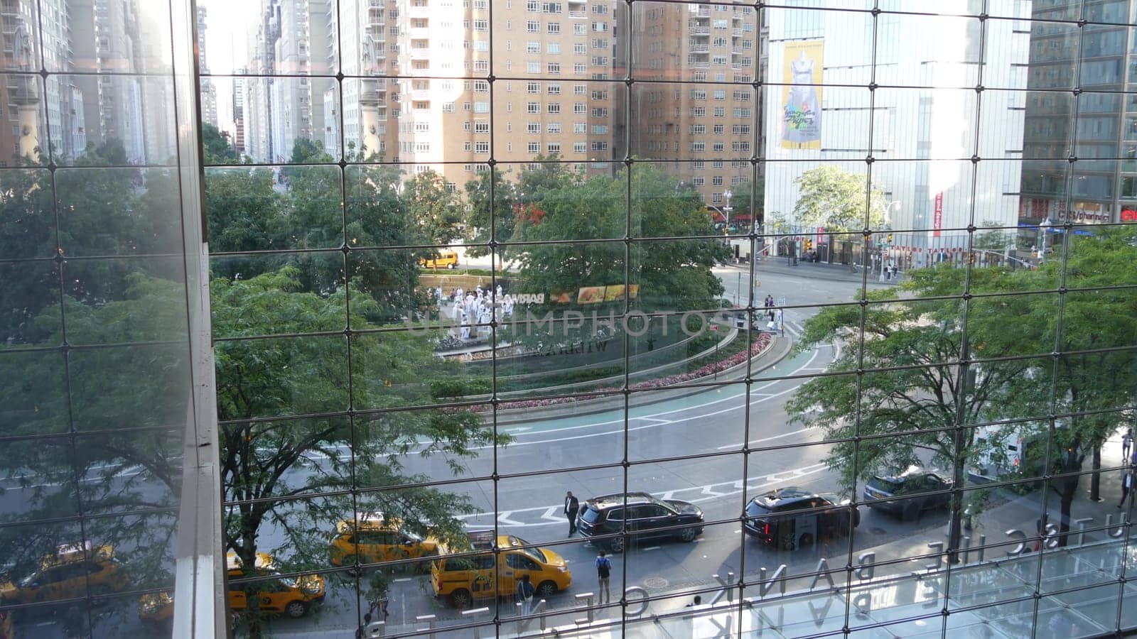 New York City, United States - 14 Sept 2023: Columbus Circle, Broadway street near Central Park. Manhattan Midtown architecture. USA urban road traffic thru window of Deutsche Bank Center. Yellow taxi