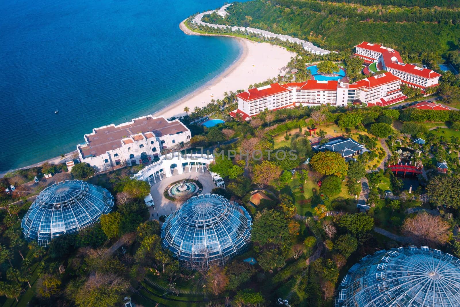 Luxury hotel at sea with sandy beach in Hon Tre island in Vinpearl park in Nha Trang in Vietnam, top aerial view. Resort in Asia for summer vacation