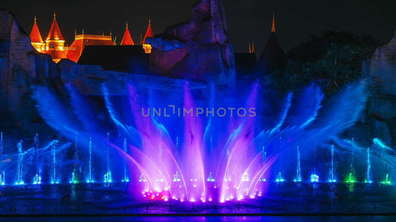 beautiful bright blue illuminated dancing and singing fountains at night. Musical water performance show