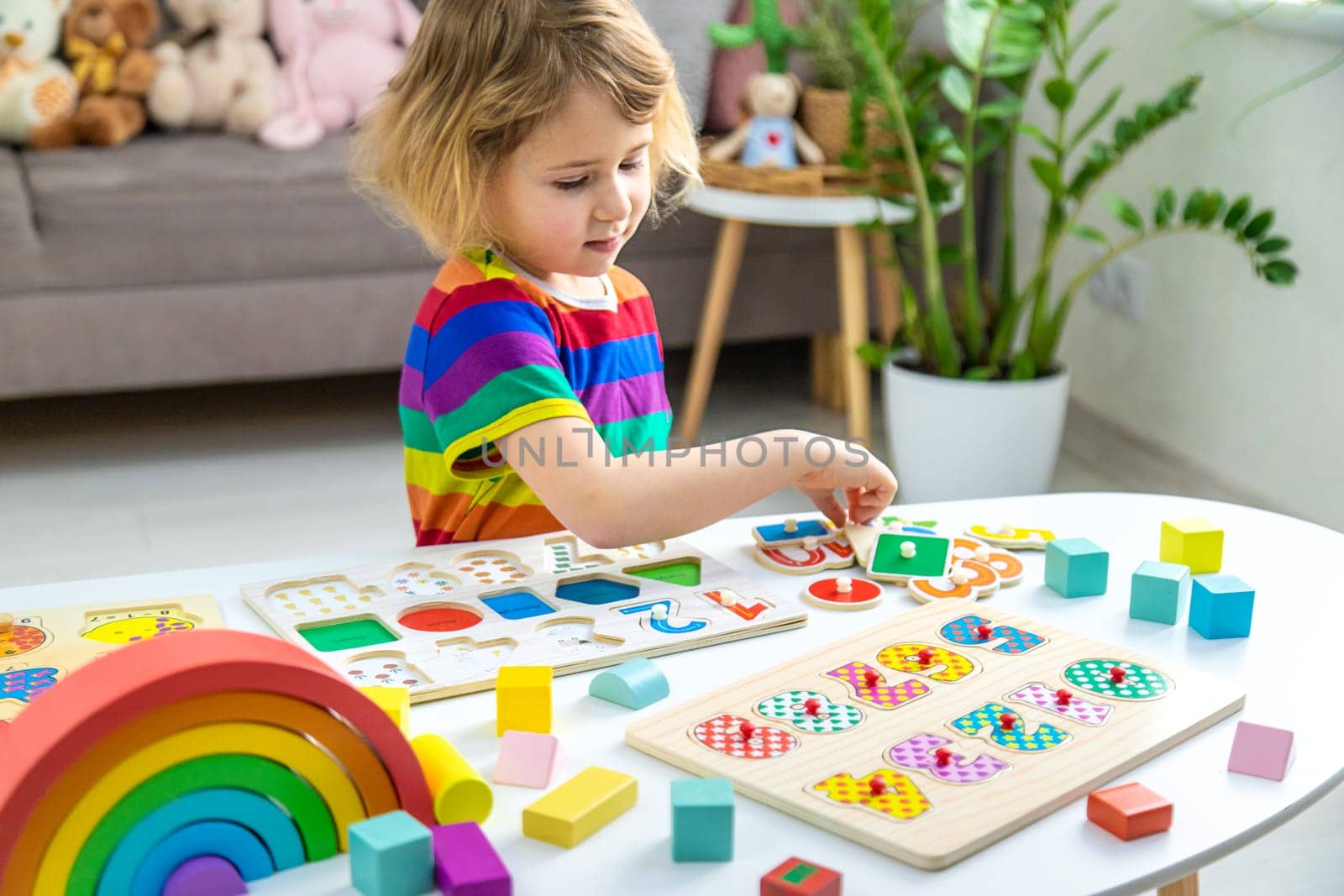 Child learns numbers and letters. Selective focus. Kid.