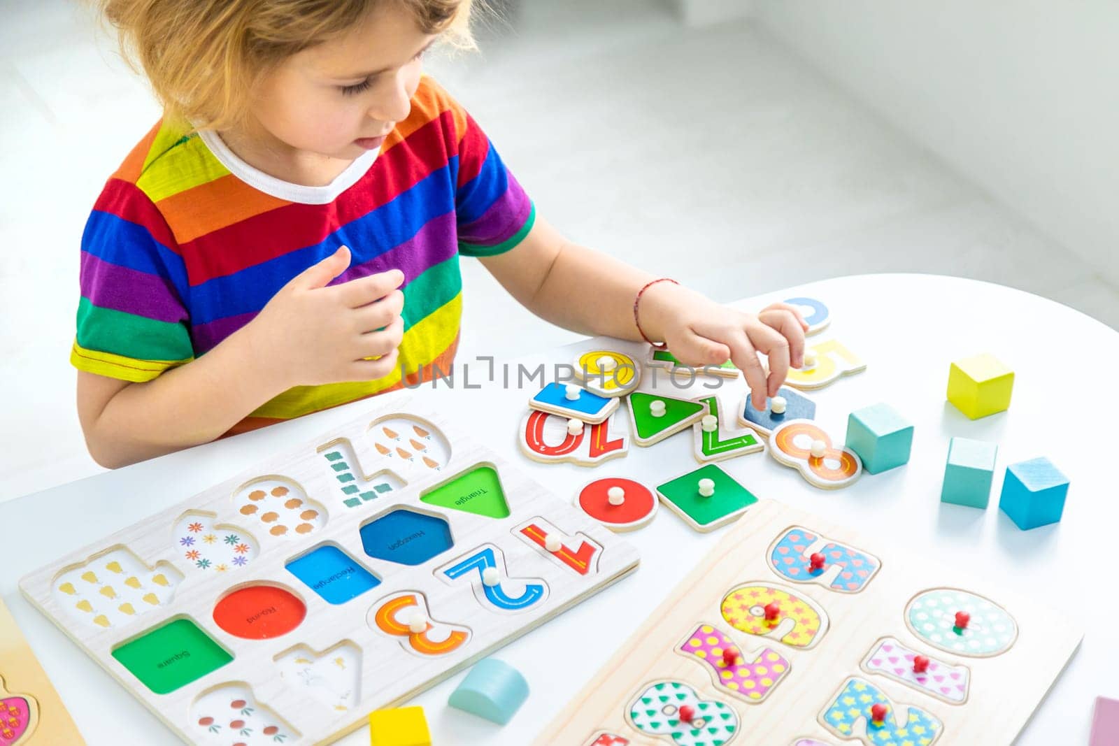 Child learns numbers and letters. Selective focus. Kid.