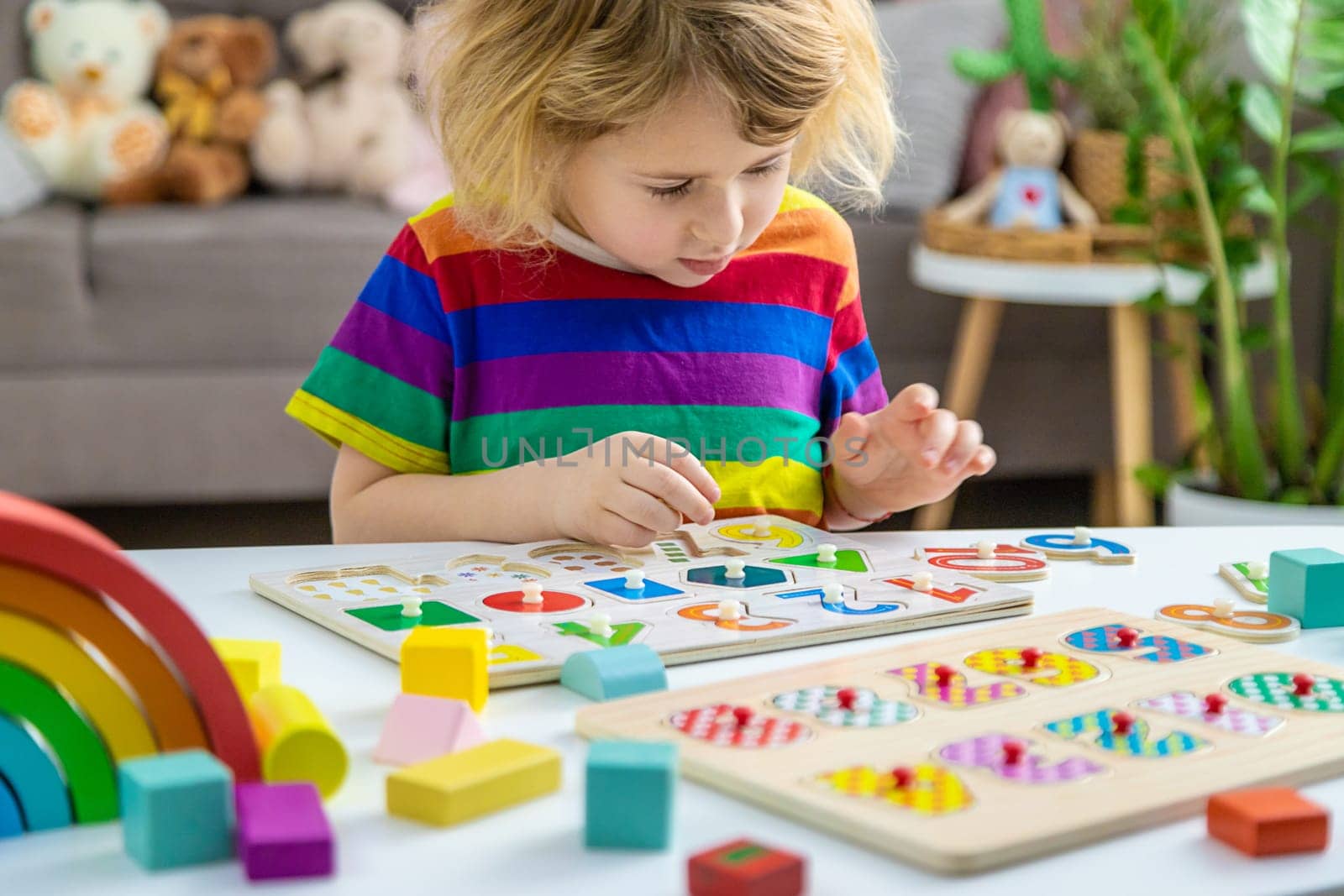 Child learns numbers and letters. Selective focus. Kid.