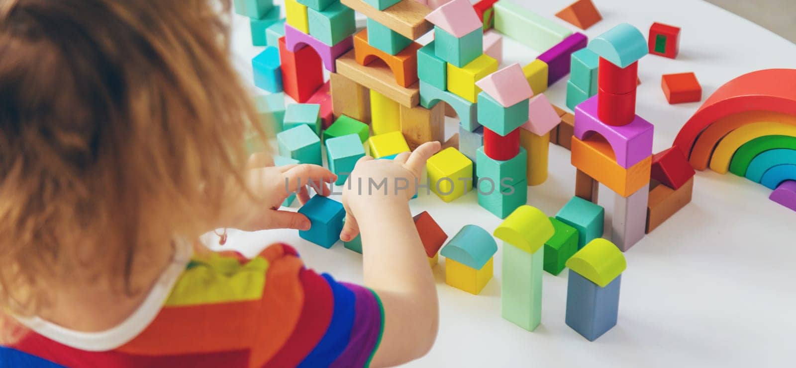 A child builds from blocks. Selective focus. kid.