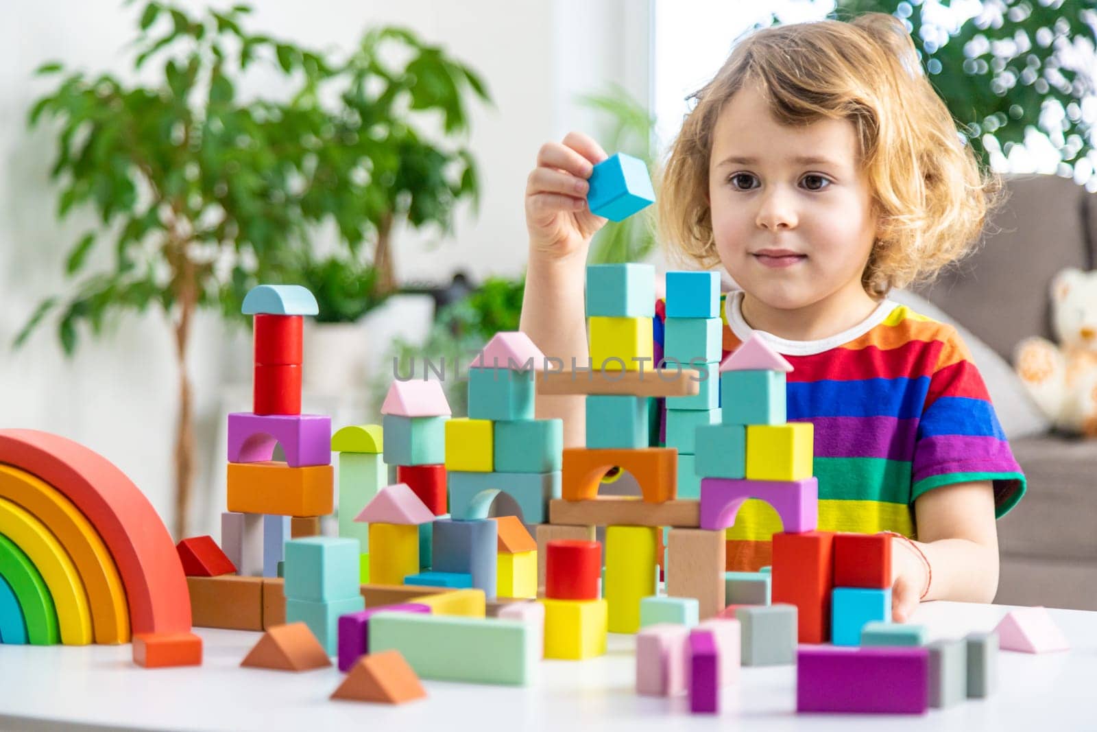 A child builds from blocks. Selective focus. kid.