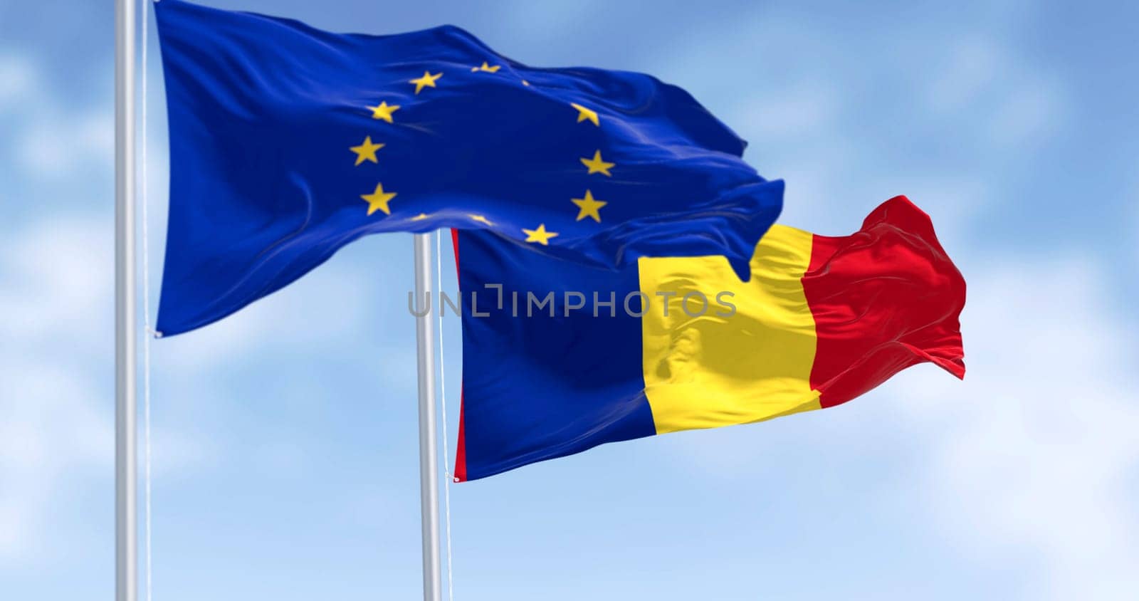 Photorealistic 3D render of Romania and European Union flags waving together in the wind. Concept of diplomacy, unity, and international relations under a bright blue sky.