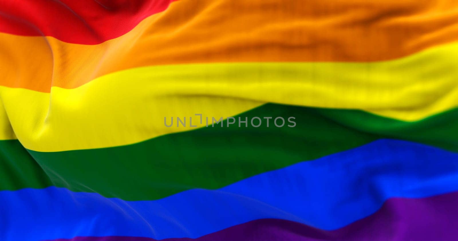 3D render of the rainbow flag fluttering in the wind, symbol of LGBTQ+ pride, freedom, equality and diversity.