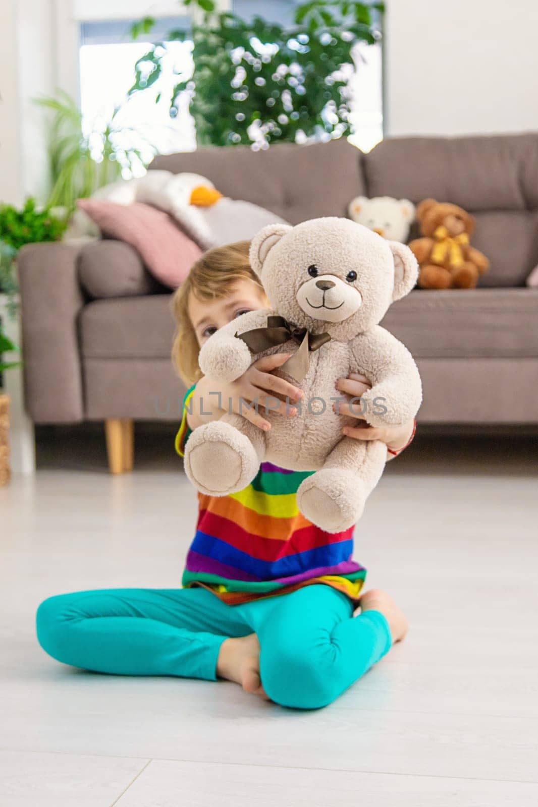 Child loves teddy bear at home. Selective focus. kid.