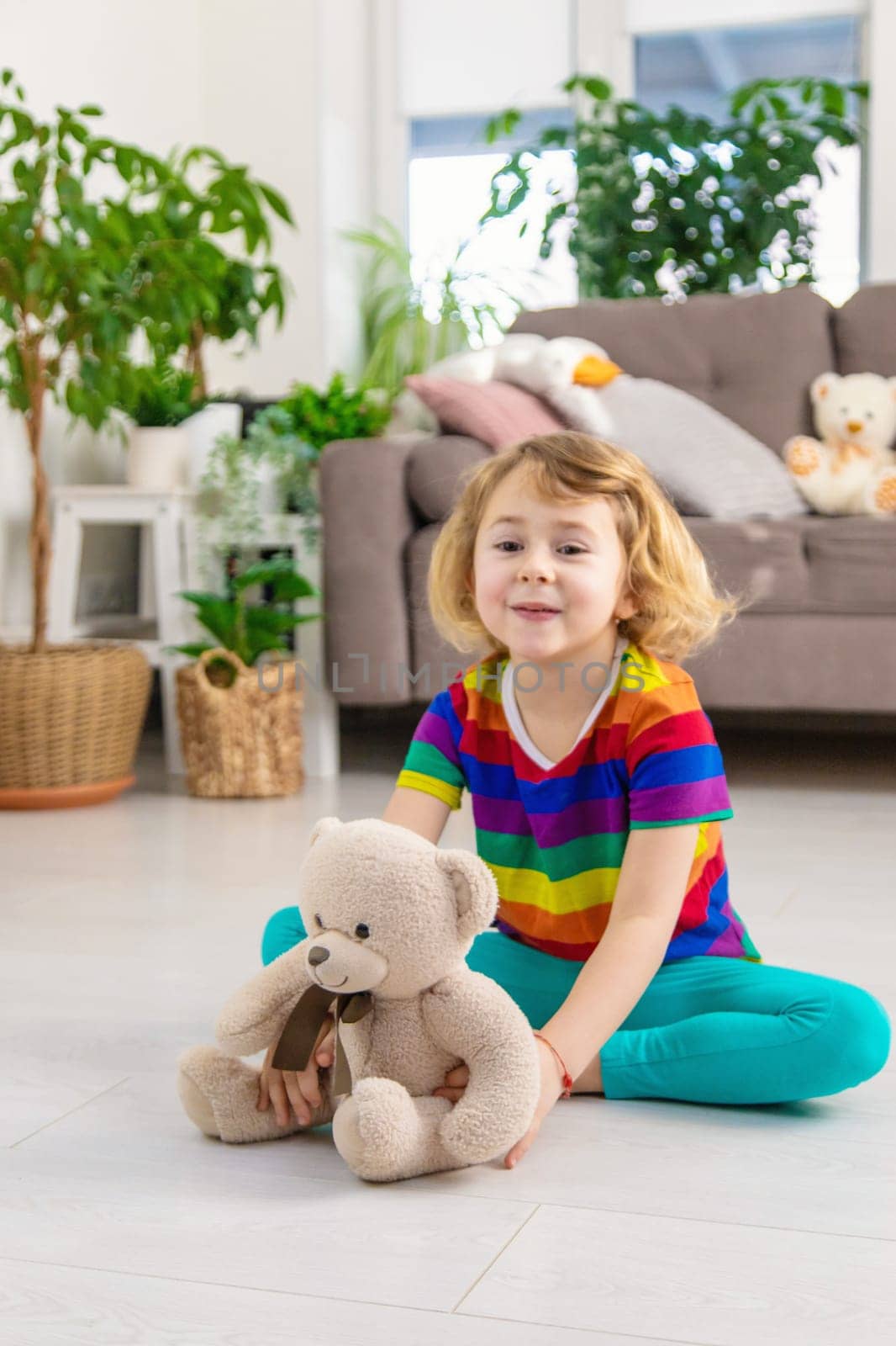 Child loves teddy bear at home. Selective focus. kid.
