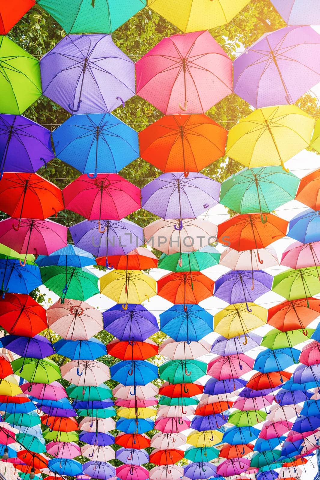 multicolored bright rainbow colorful umbrellas art decoration on festive street on Magic City Park in Tashkent in Uzbekistan