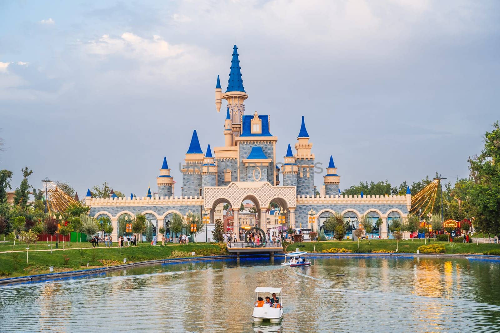 Beautiful fairy-tale castle by lake in the Magic City amusement park in Tashkent. Tashkent, Uzbekistan - July 15, 2025
