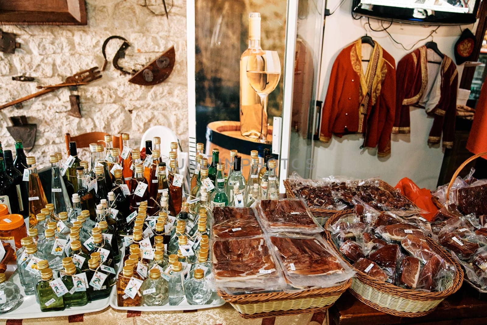 Gift shop counter with bottles of alcohol and packaged cold cuts. High quality photo