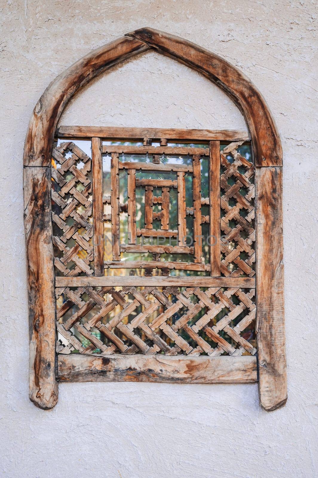 old antique Uzbek wooden window with traditional carved pattern in Uzbekistan