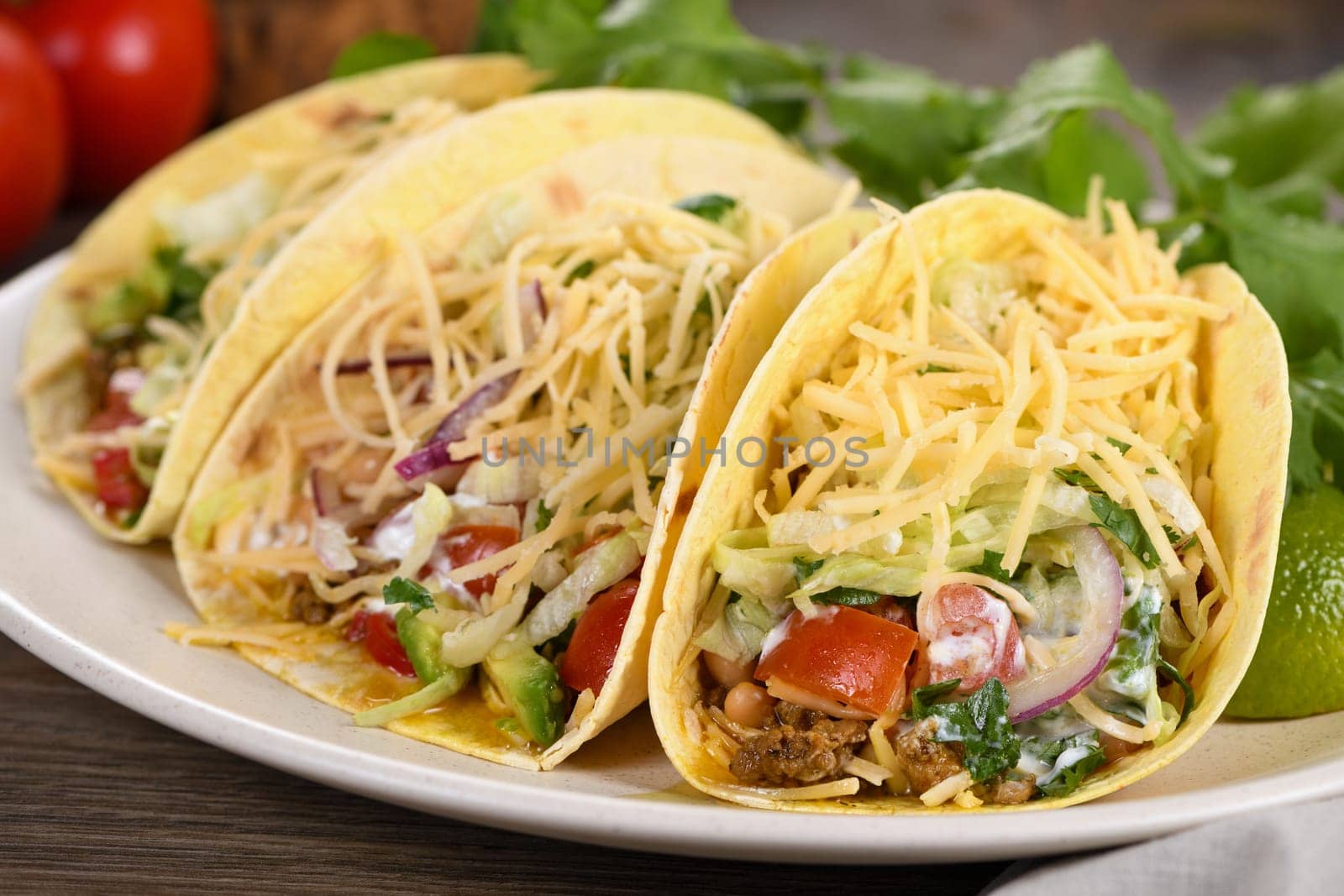 Taco with ground beef and avocado, cabbage and cheese. Mexican cuisine. Close-up.