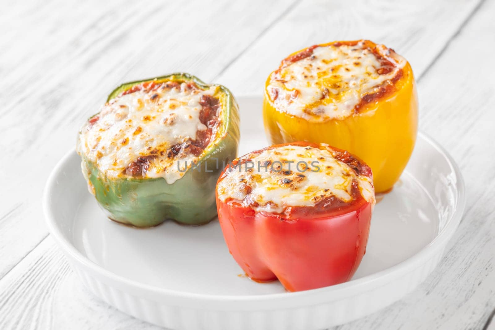 Vibrant bell peppers are baked to perfection, generously stuffed with rich bolognese sauce, and crowned with melted mozzarella