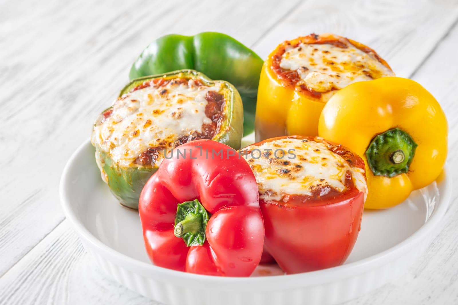 Vibrant bell peppers are baked to perfection, generously stuffed with rich bolognese sauce, and crowned with melted mozzarella