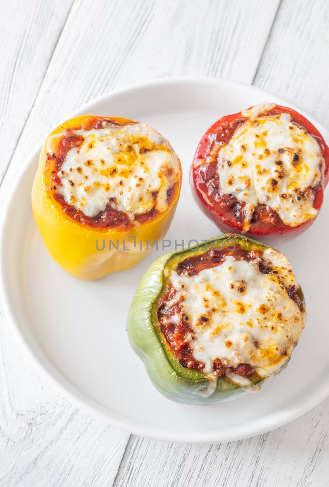 Vibrant bell peppers are baked to perfection, generously stuffed with rich bolognese sauce, and crowned with melted mozzarella