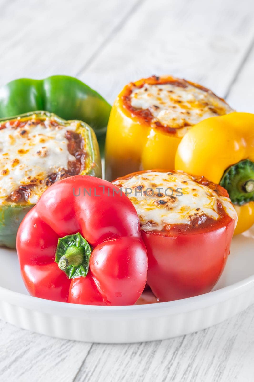 Vibrant bell peppers are baked to perfection, generously stuffed with rich bolognese sauce, and crowned with melted mozzarella