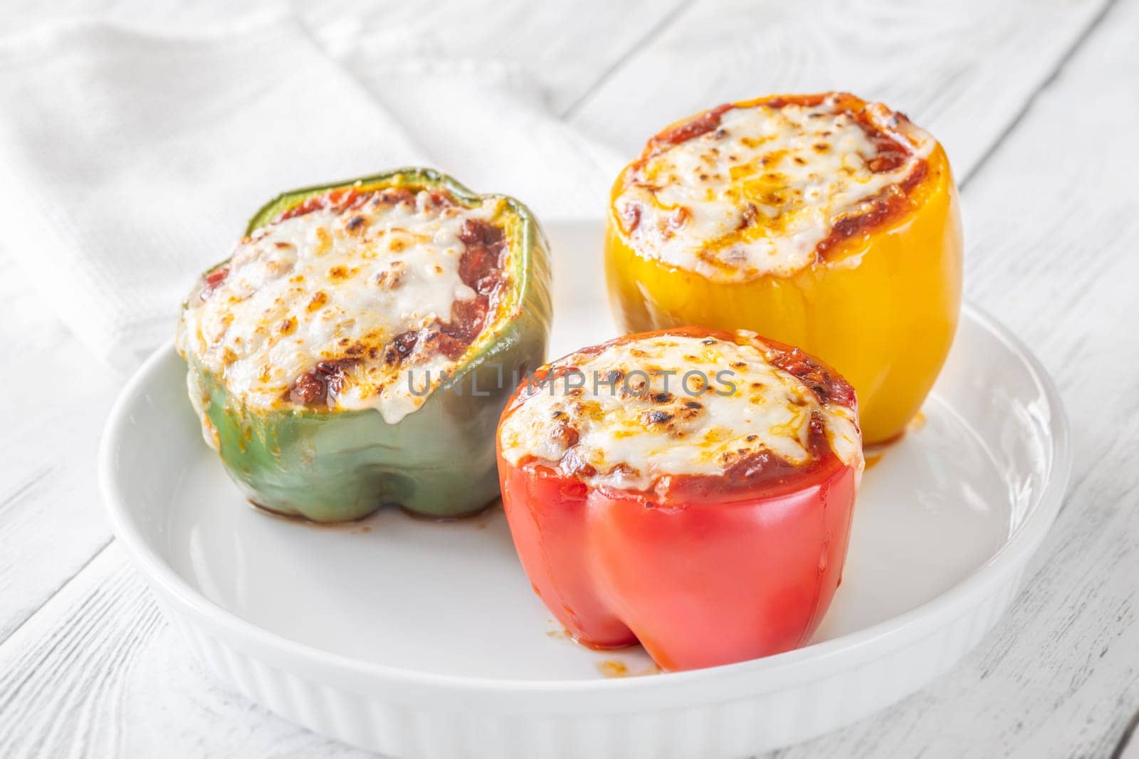Vibrant bell peppers are baked to perfection, generously stuffed with rich bolognese sauce, and crowned with melted mozzarella