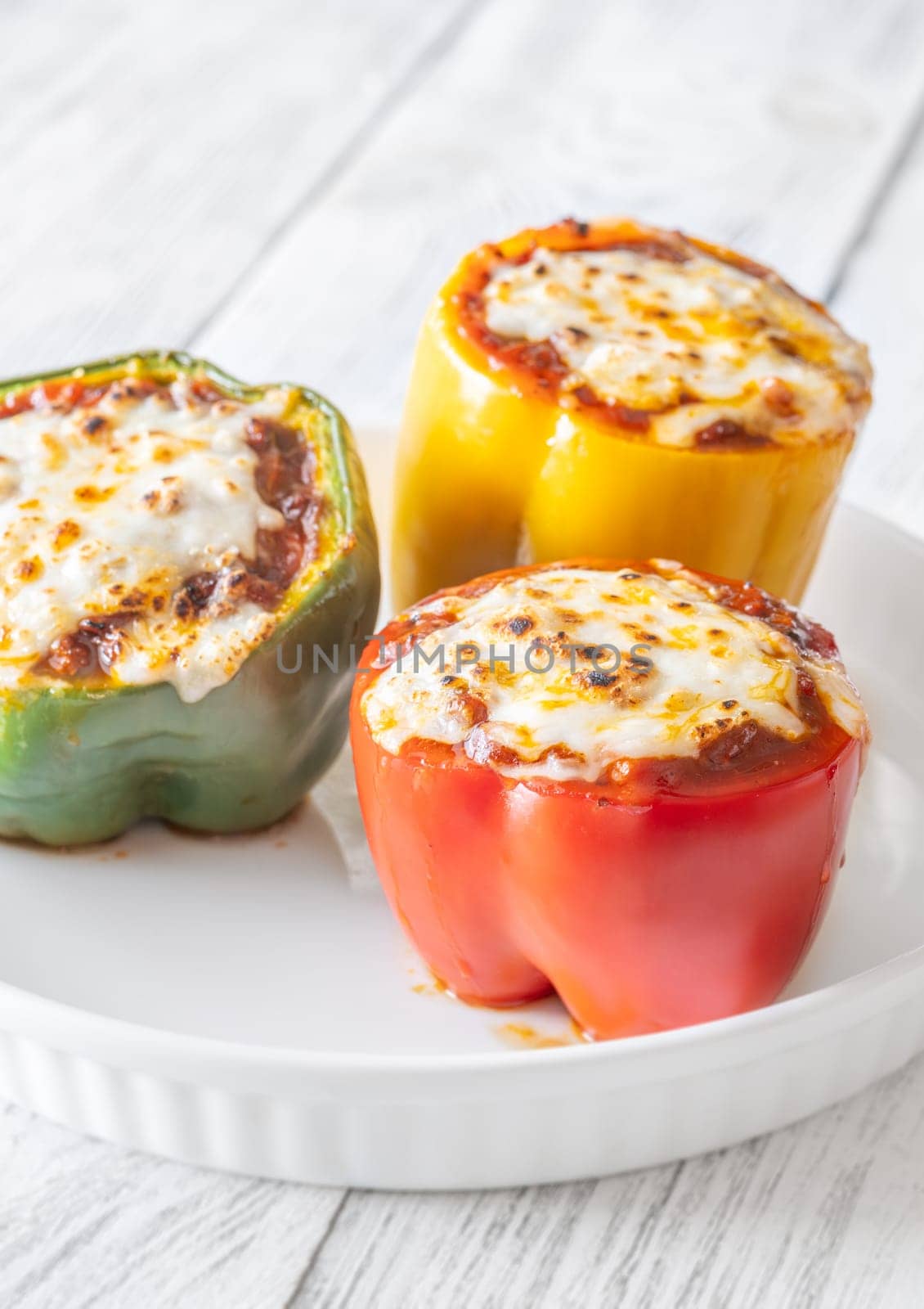 Vibrant bell peppers are baked to perfection, generously stuffed with rich bolognese sauce, and crowned with melted mozzarella