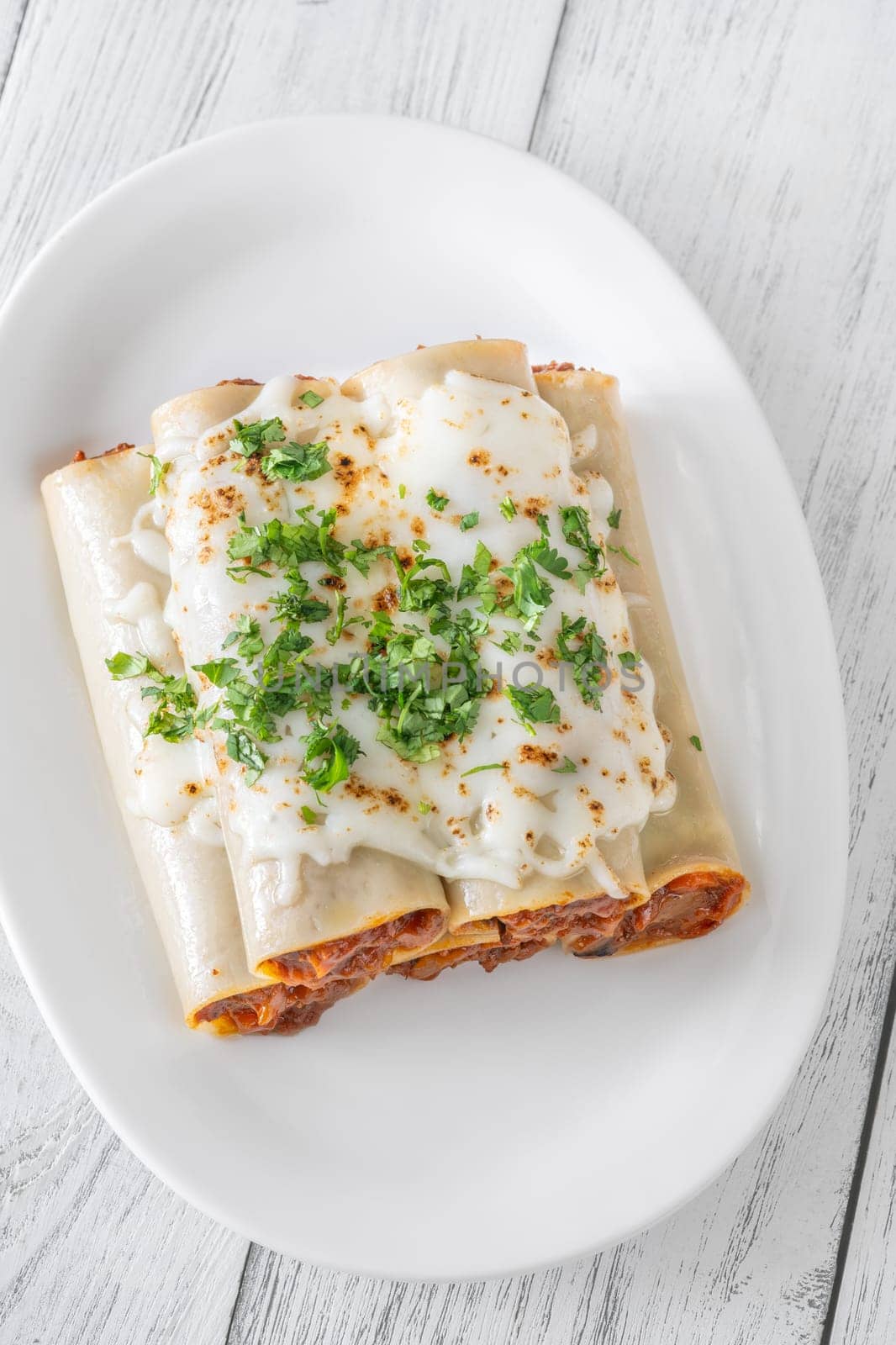Delicate cannelloni pasta, generously filled with rich bolognese sauce, baked under a blanket of melted mozzarella