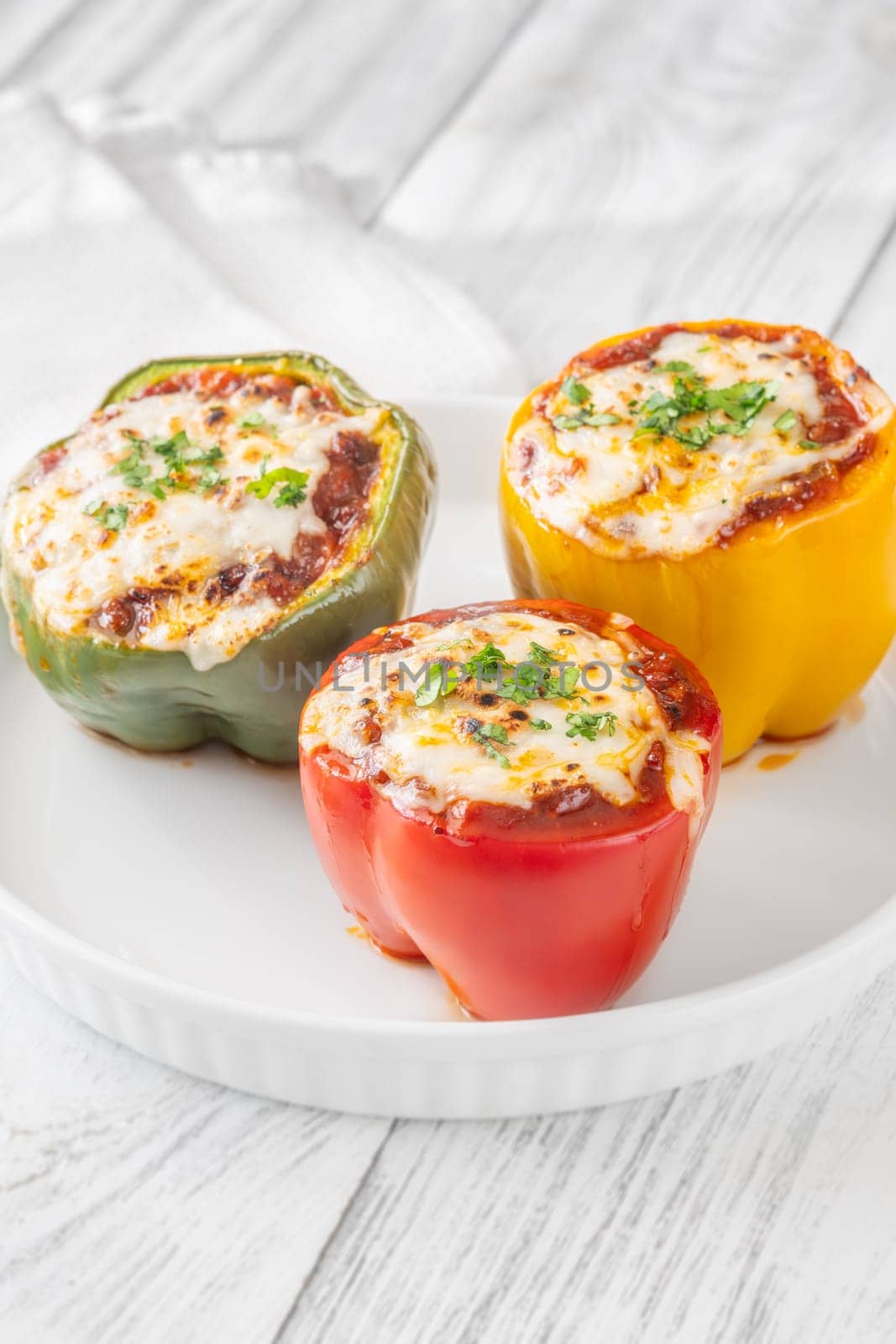 Vibrant bell peppers are baked to perfection, generously stuffed with rich bolognese sauce, and crowned with melted mozzarella