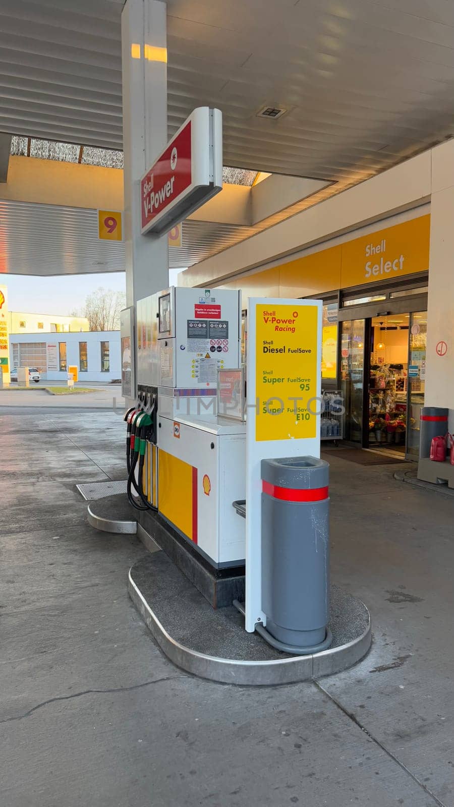 22.03.2025 Germany: Modern Shell Gas Station With Fuel Pumps and Convenience Store Exterior View. Urban Schell gas station featuring fuel pumps, brand signage, and an attached convenience store offering refreshments. Ideal depiction of modern fueling service facilities and retail amenities catering to customer needs.