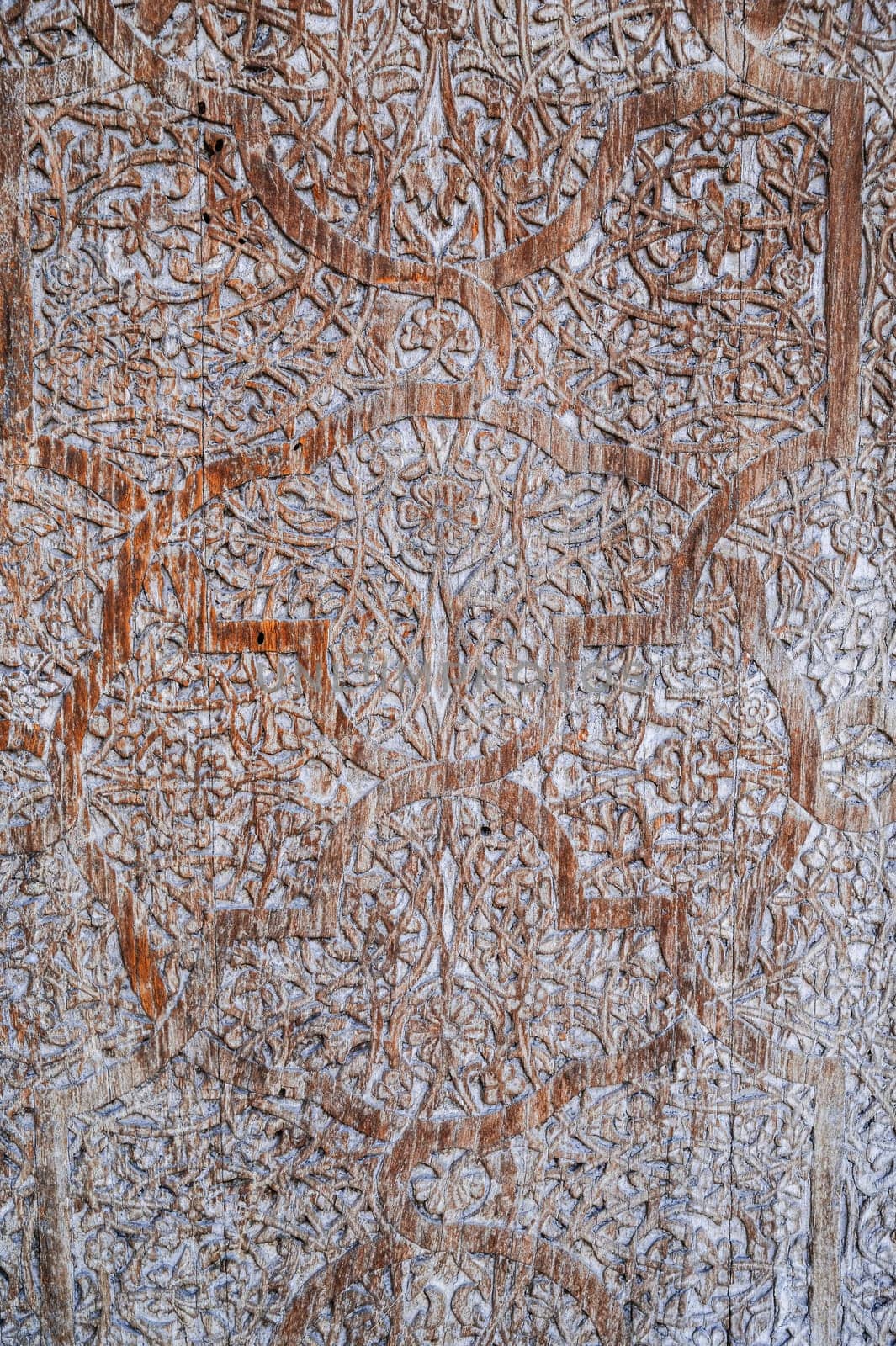 traditional Uzbek retro carved pattern kandakori on vintage old wooden door in Tashkent in Uzbekistan close-up
