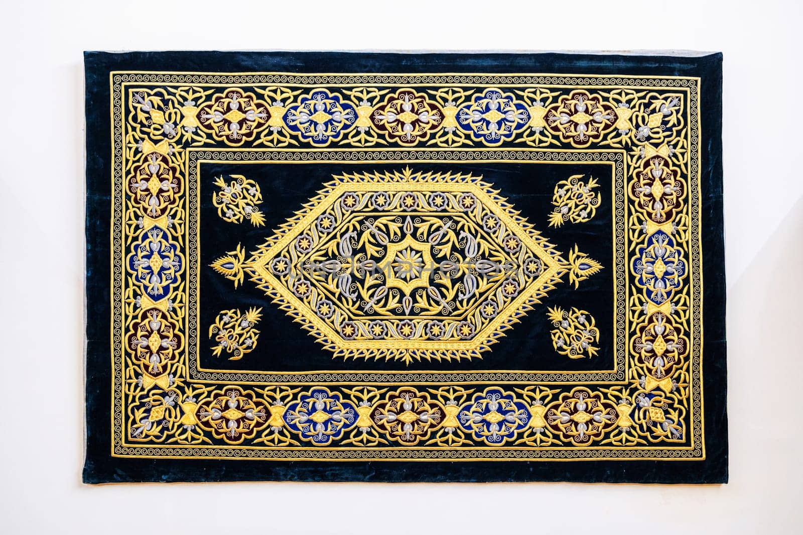 oriental Uzbek carpet with a traditional abstract geometric pattern. Vintage luxury handmade Turkish carpet on a white isolated background