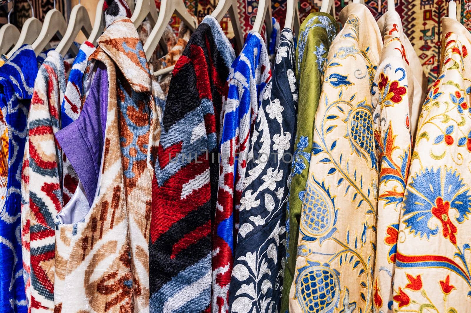 traditional festive Uzbek colorful dresses, costumes and robes at the oriental market in Uzbekistan