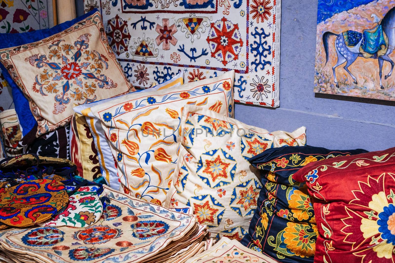 traditional Uzbek handmade pillows and vintage carpet in the interior of a house in Uzbekistan. Culture of Central Asia