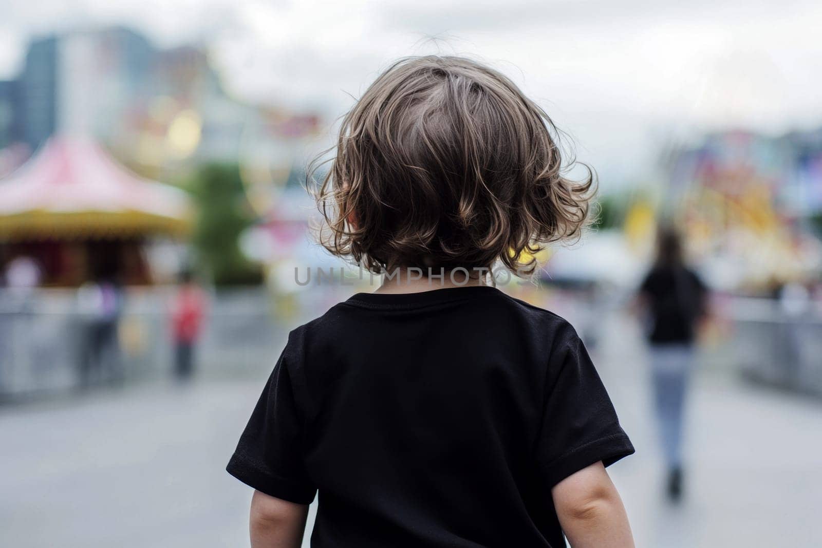 reaa shot A child stands at a vibrant playground, viewing the colorful slides..