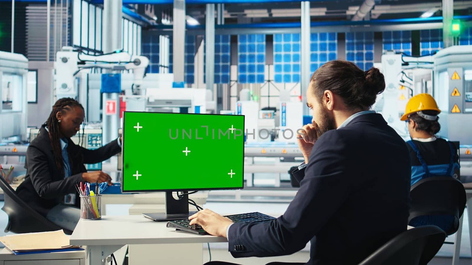 Photovoltaics factory worker analyzing data on green screen PC, reviewing system metrics. Solar panels manufacturing plant employee troubleshooting technical issues using chroma key computer, camera A