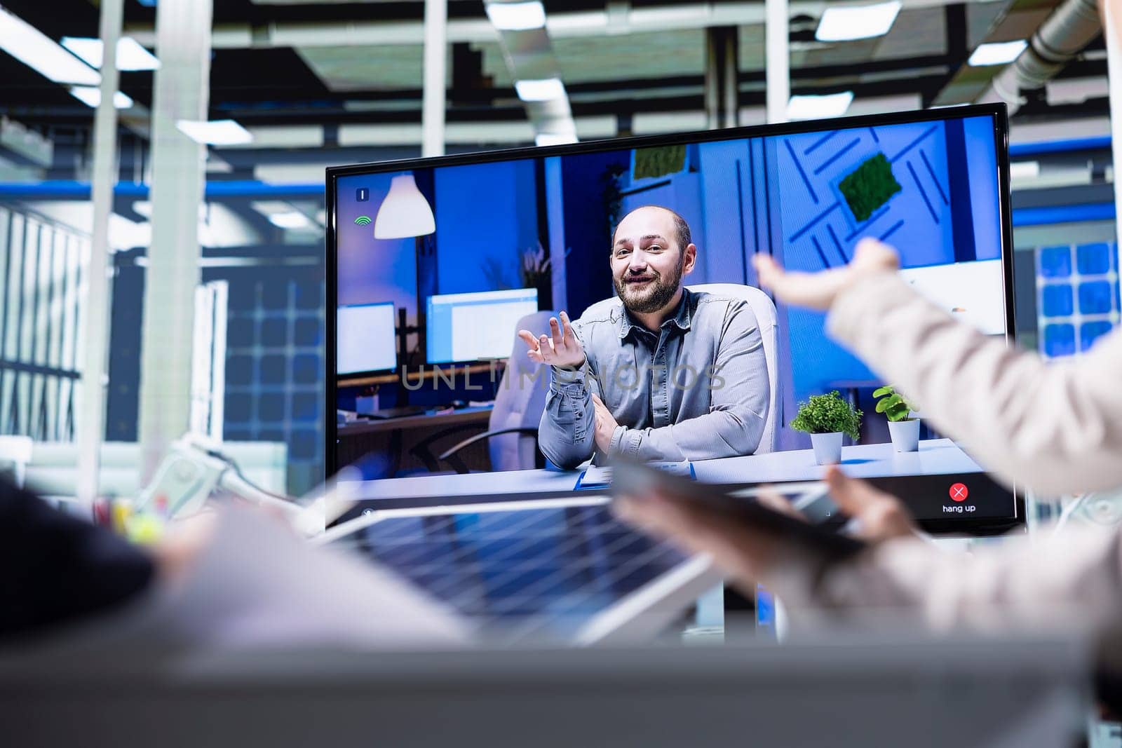 Photovoltaics factory managers talk to clients about solar energy benefits during remote videoconference. Industrial plant sales team deliver product pitch to investors during online video call