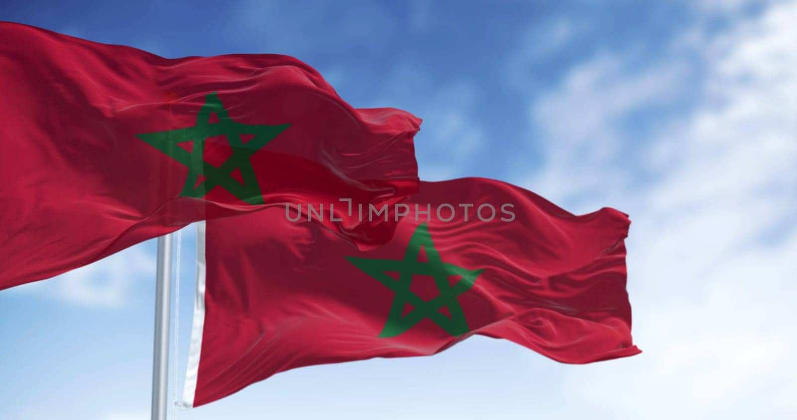 Morocco national flags waving in the wind on a clear day. Red flag with a green pentagram in the center. 3d illustration render. Rippled fabric. Selective focus