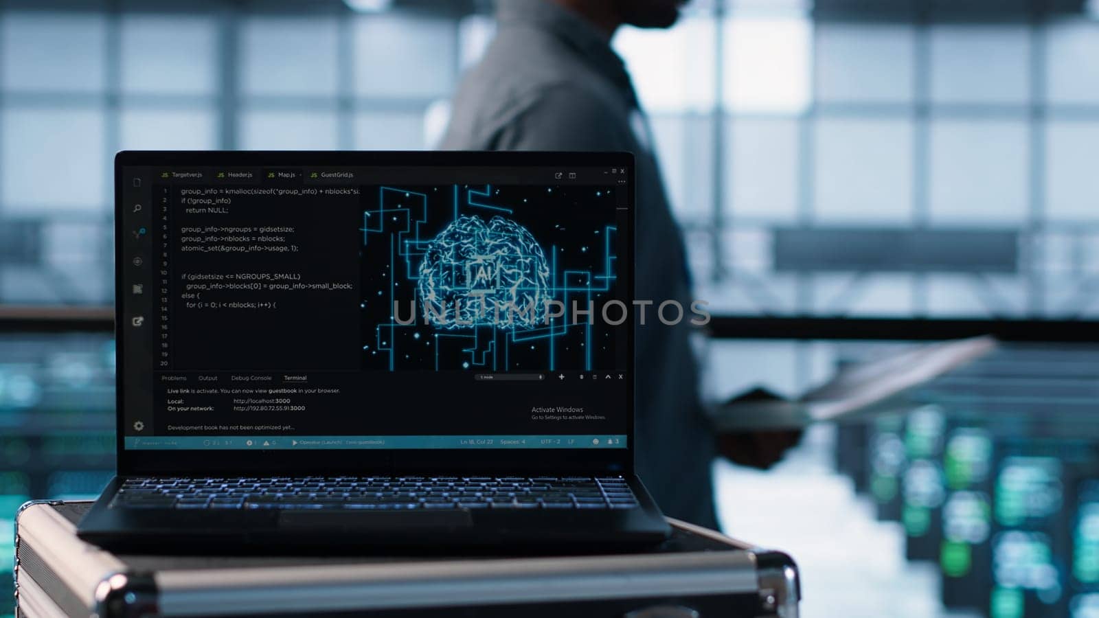 Artificial intelligence technology coding on laptop in data center with programmers in background employing machine learning models. Notebook used by AI IT experts, camera A close up