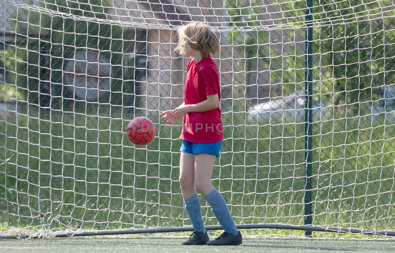 Girl Goalkeeper Stands At Goalposts During Children'S Football Match
