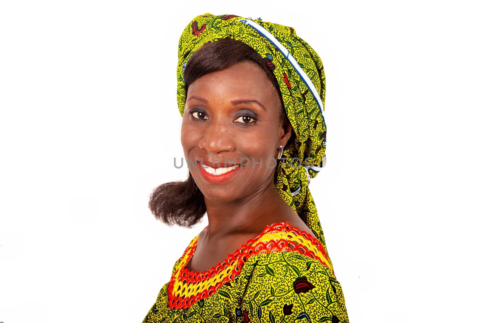 beautiful African adult woman dressed in green loincloth is smiling.