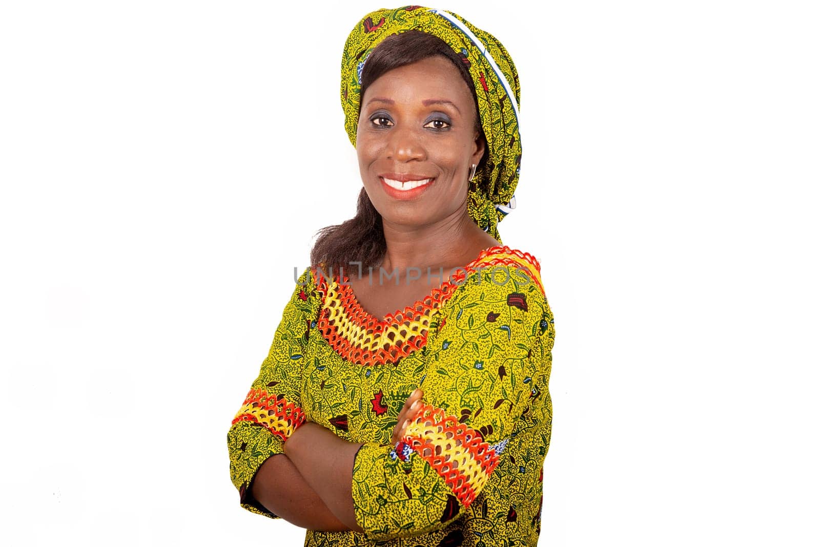 beautiful African adult woman dressed in green loincloth is smiling while crossing her arms