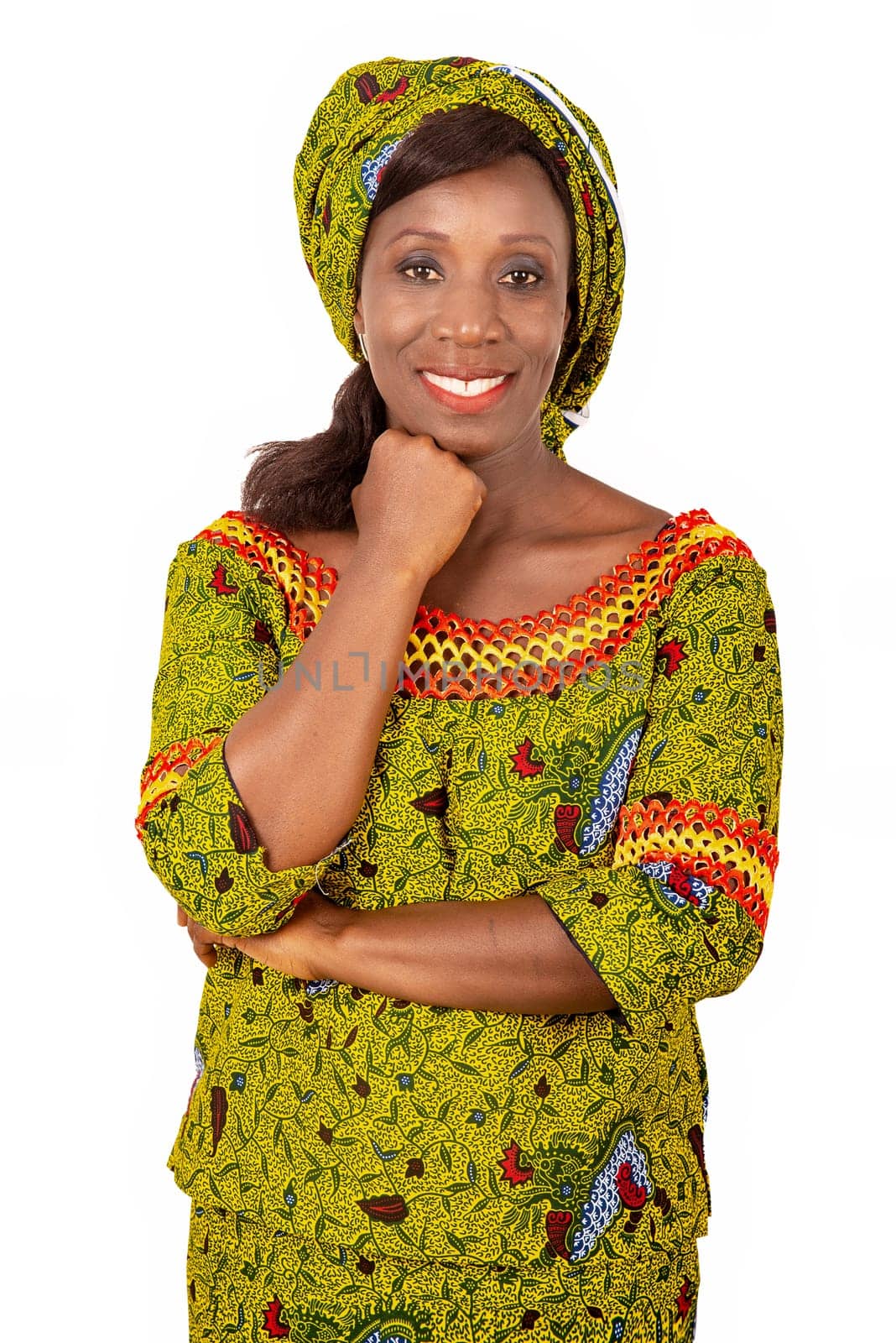 beautiful adult african woman dressed in green loincloth is smiling with arm on chin