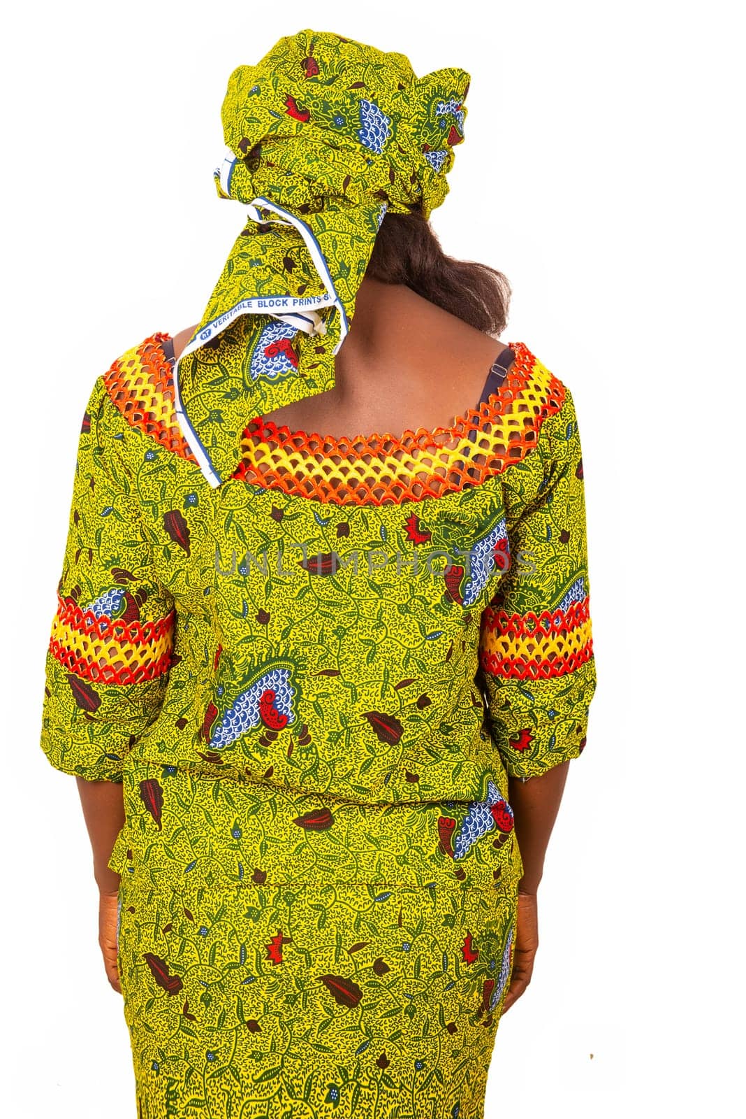 African adult woman presenting her beautiful outfit in green loincloth, with short sleeves in the back.