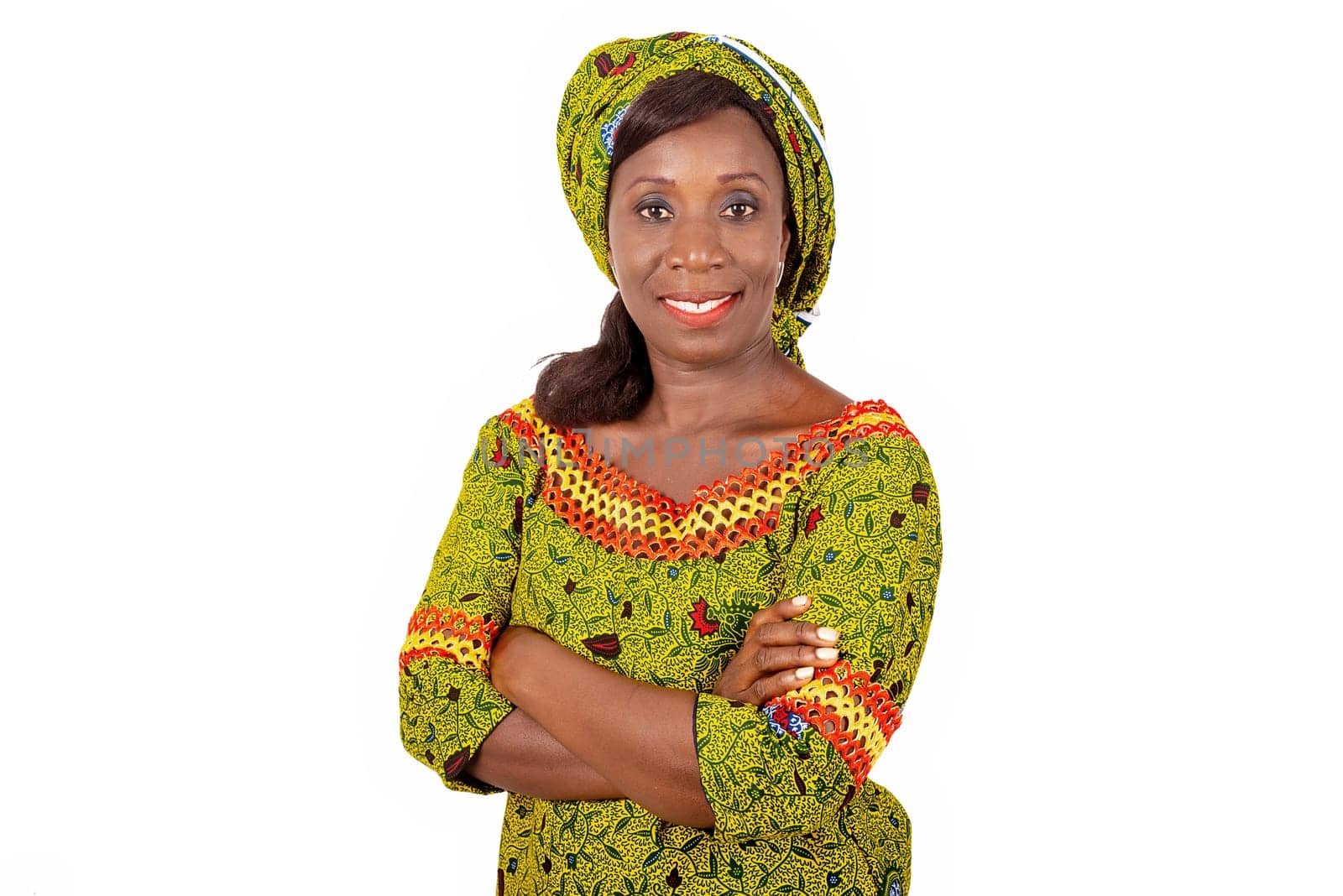 beautiful African adult woman dressed in green loincloth is smiling while crossing her arms
